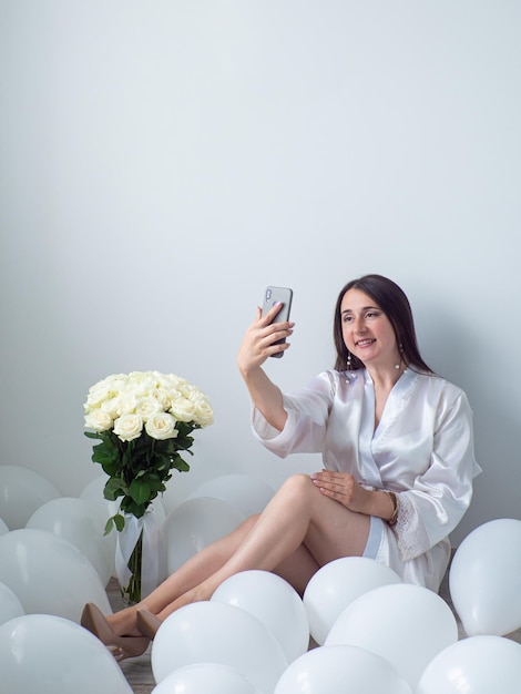 Woman sitting in decorations with balloons for Birthday party