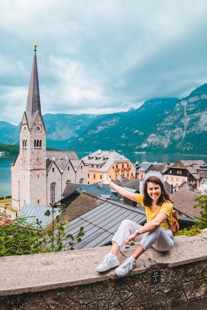 Woman sitting and enjoying the vie of hallstatt austria