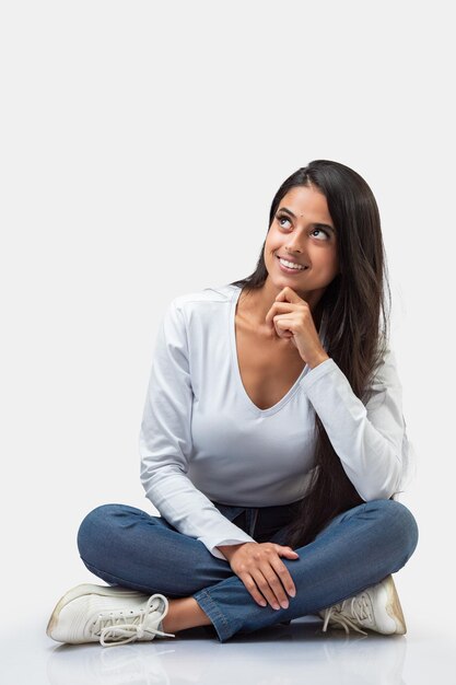 A woman sitting on the floor looking up