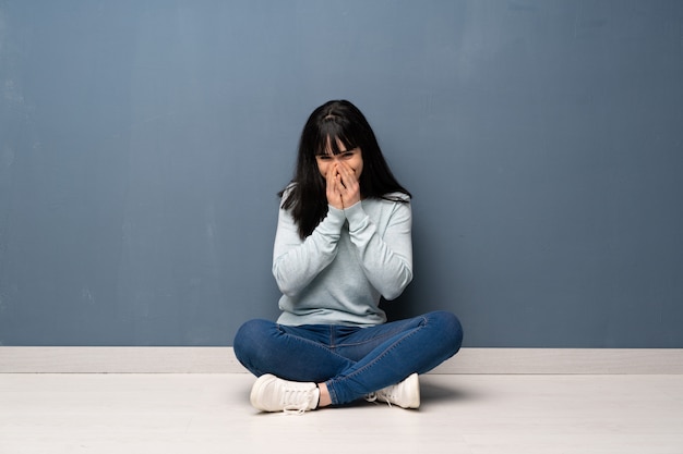 Woman sitting on the floor smiling a lot