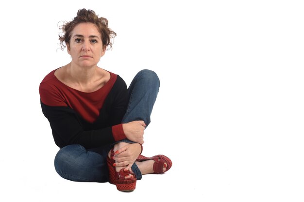 Woman sitting on the floor on white background