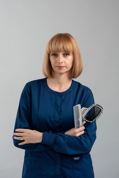 Woman sitting on a grey background Formal dark blue suit Doctor pottrait