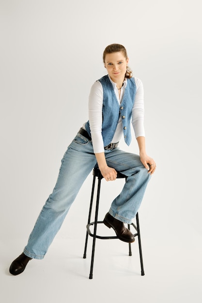 Woman sitting on a high chair with her leg stretched to the side