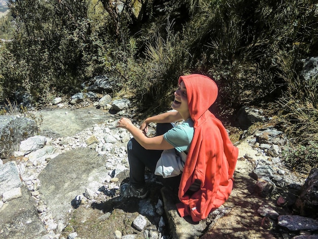 Woman sitting on a rock in the middle of nature