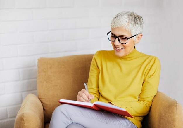 Woman sitting on sofa at home