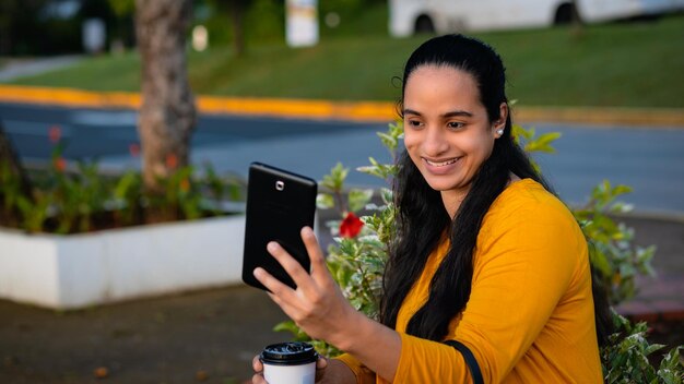 woman sitting taking a photo with mobile