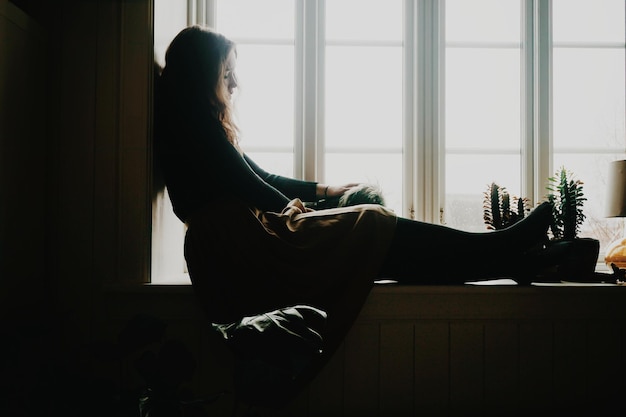 Woman sitting in window