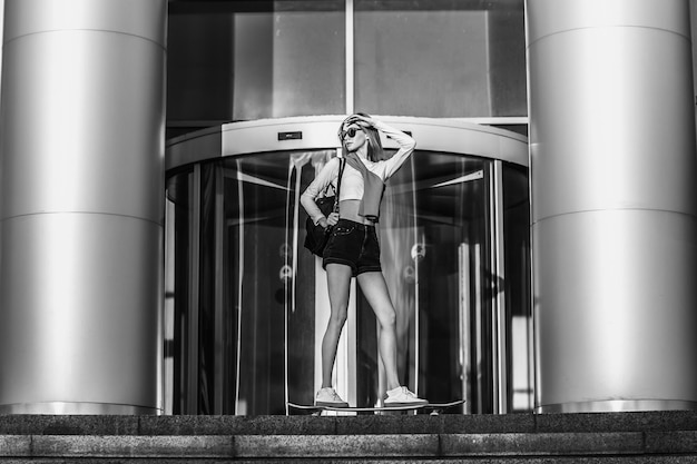 Woman on a skateboard in the city beautiful contrasting black and white photo of a woman riding