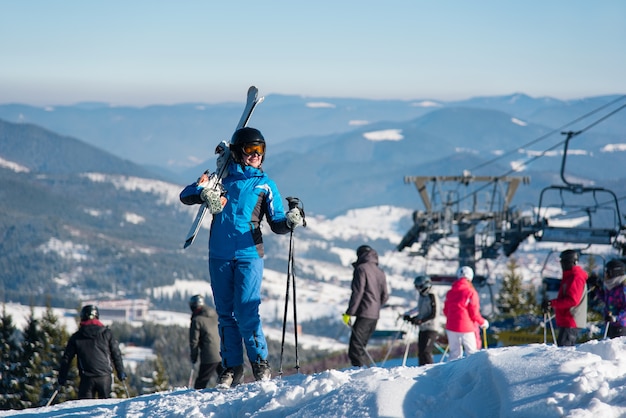 Woman skier on slope at ski resort in winter