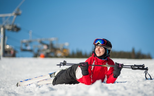 Woman skier with ski at winer resort in sunny day