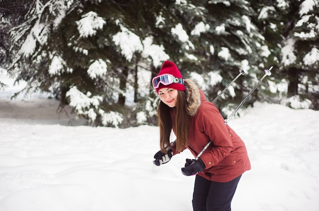 Woman skiing in the winter forest. Inexperienced skier skiing training. Young caucasian woman skier