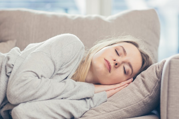  woman sleep resting at home on couch after a hard days