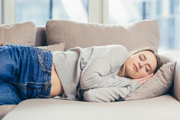  woman sleep resting at home on couch after a hard days