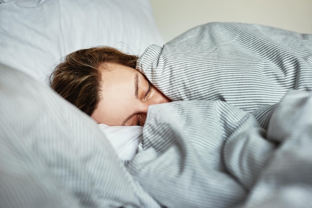 Woman sleeping in the bed at morning