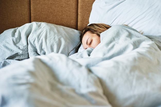 Woman sleeping in the bed at morning