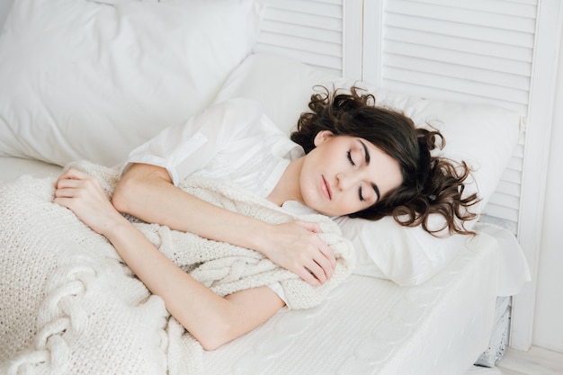 Woman sleeping in bed 