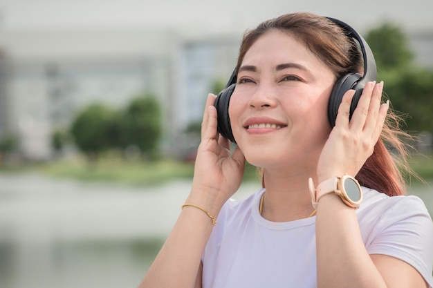 Woman smile happy listening music relax outdoor