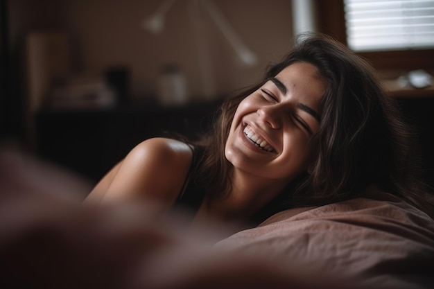 A woman smiles while lying on a bed with her braces on her.