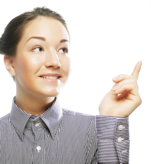 Woman smiling pointing up showing copy space