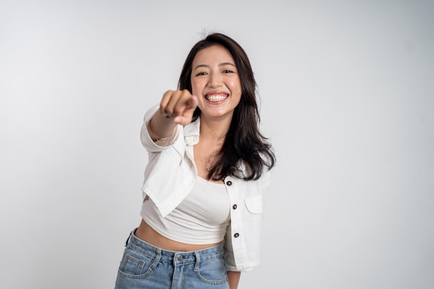 Woman smiling while pointing her finger toward camera