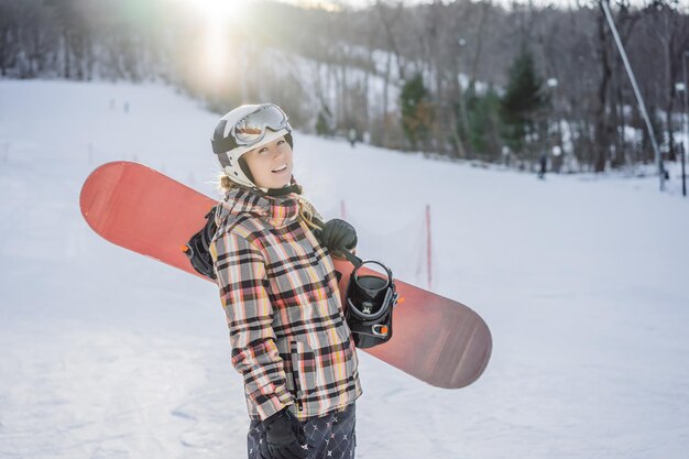 Woman snowboarder on a sunny winter day at a ski resort