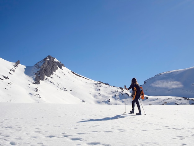 Woman snowshoeing in San Isidro, León, Spain on a sunny day