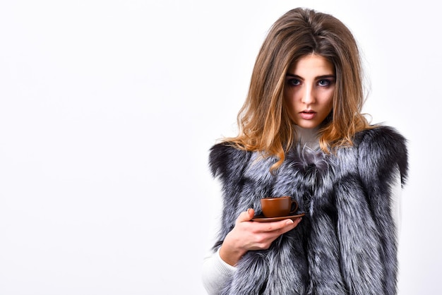 Woman splendid makeup wearing luxurious fur coat drinking hot coffee. Elite coffee concept. Pretty lady drink coffee little ceramic cup white background. Enjoy luxurious aroma and taste hot coffee.