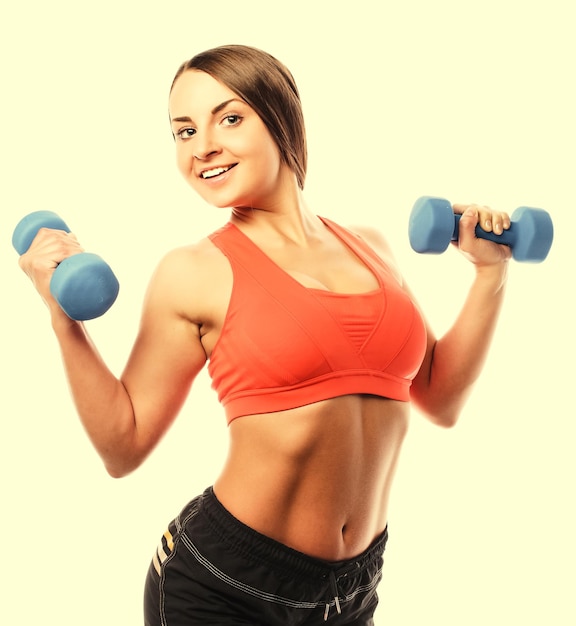 Woman in sport equipment practice with hand weights