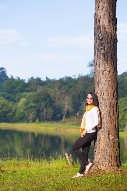 Woman standing against the tree