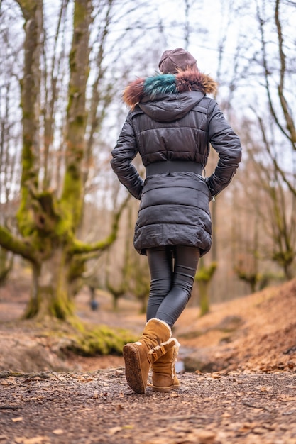 A woman standing in a beautiful forest