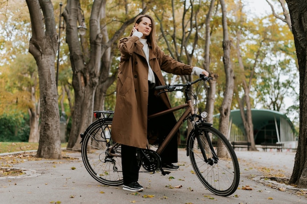 Woman standing on the bicycle long shot