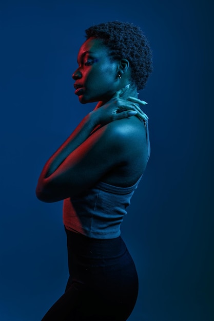 Woman standing gracefully over dark studio background