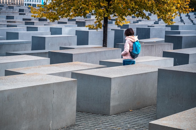 Woman standing between stelae of Holocaust Memorial