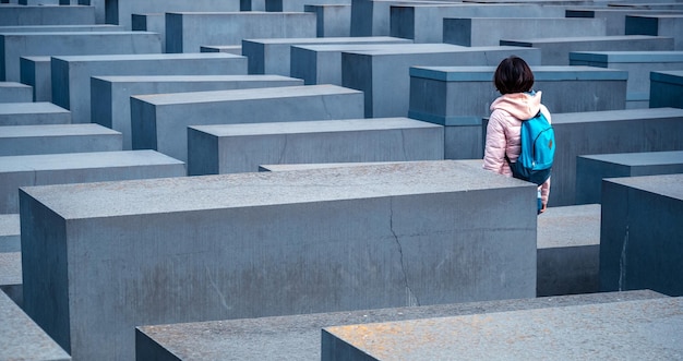 Woman standing between stelae of Holocaust Memorial