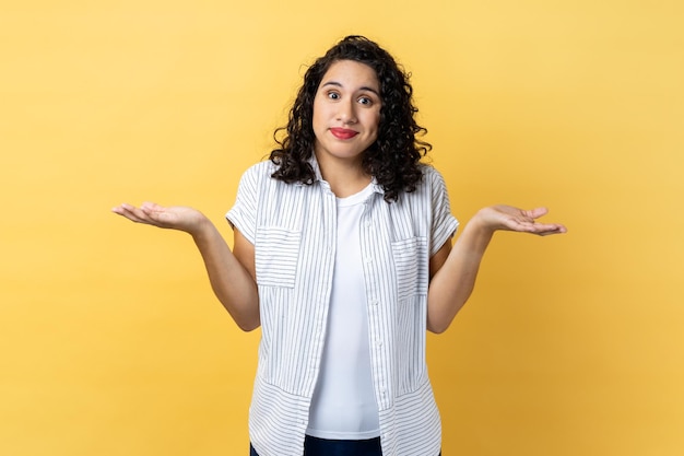 Woman standing with raised arms looking away and don't know what to do