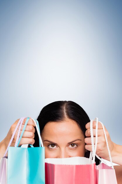 Photo woman standing with shopping bags against blue vignette