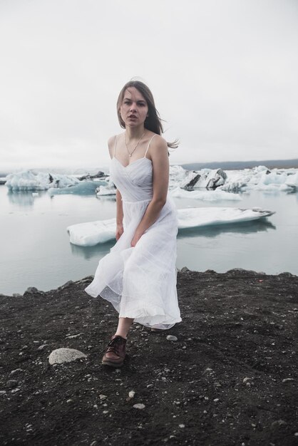 Woman stands against the background of glaciers in Iceland