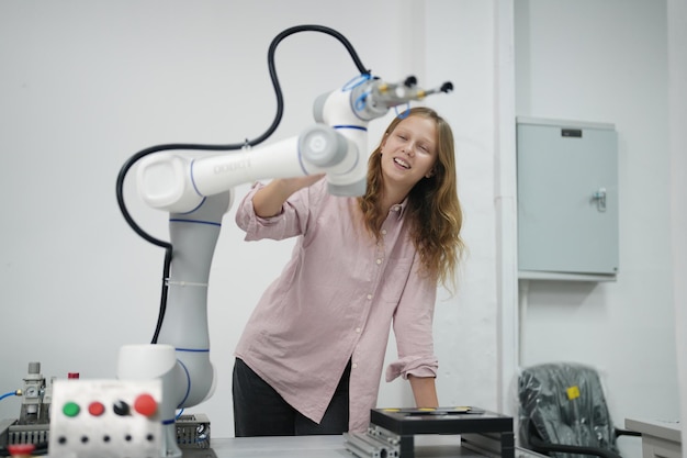 A woman stands next to a robot that says'robot '