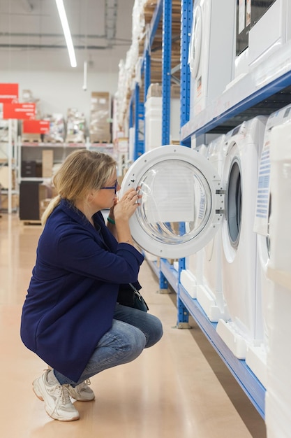 Woman in store choosing washing machine