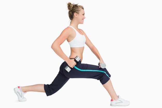 Woman stretching while holding weights