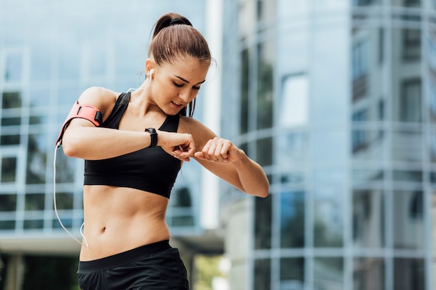 Woman stretching with glass building behind