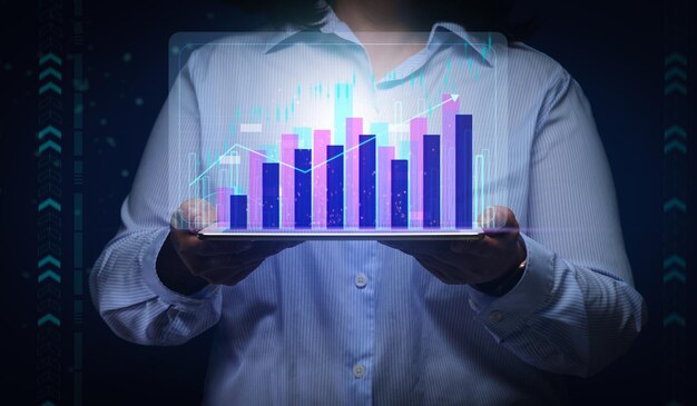 a woman in a striped shirt holds a tablet with a virtual holographic chart on a dark blue background Concept of performance growth successful business income growth