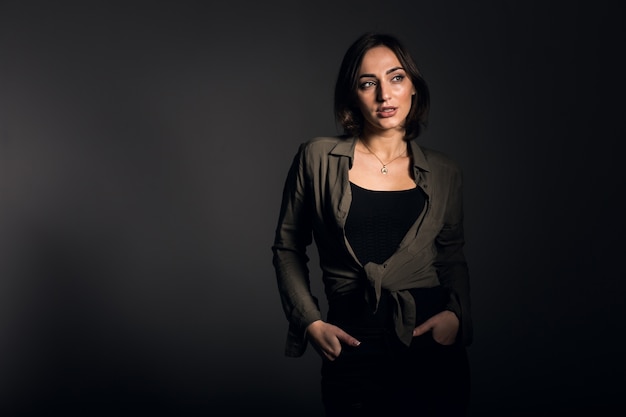 Woman in studio on black background