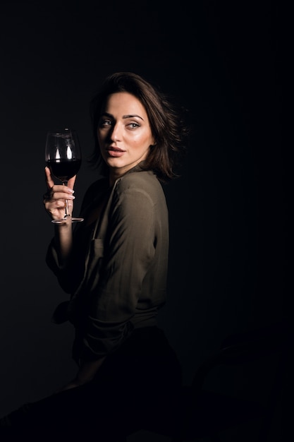 Woman in studio on black background