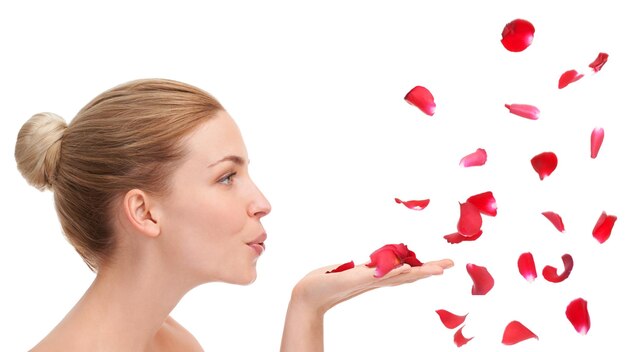 Photo woman studio and blow with rose petals in profile for natural beauty skincare or wellness by white background girl model or person with flowers for celebration organic confetti or valentines day