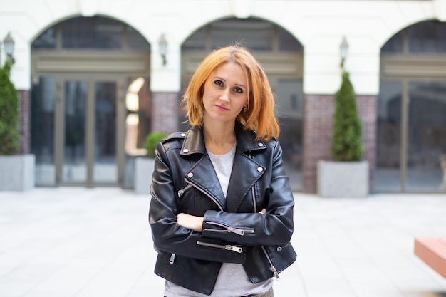 Woman in stylish clothes outdoors on urban background