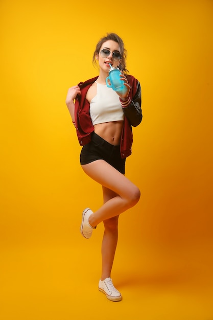 Woman in stylish jacket with drinking jar