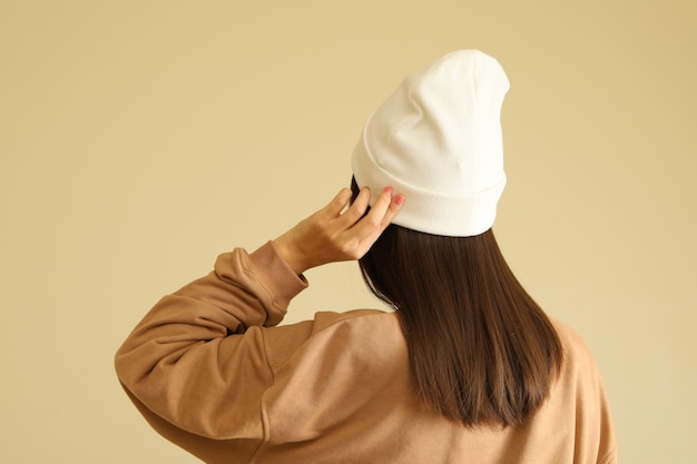 Woman in stylish sweatshirt and beanie