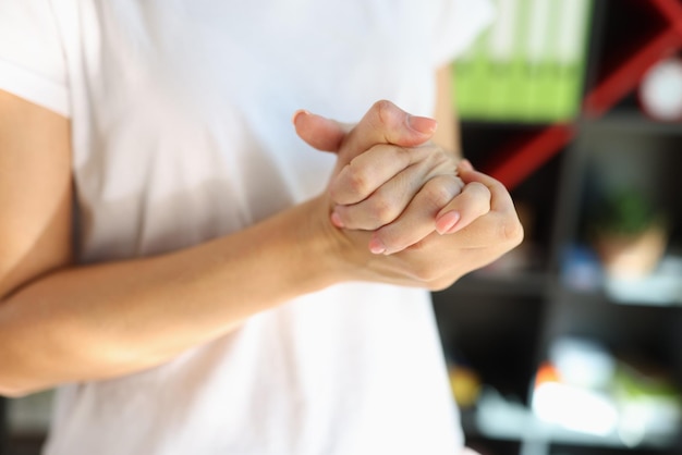 Photo woman suffering because pain in her hands close up of female massaging her overworked hands