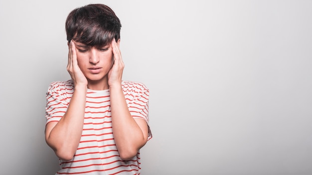 Woman suffering from head pain isolated white background